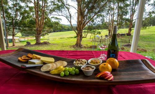 a tray of food and a bottle of wine on a table at Karrak Reach Forest Retreat in Denmark