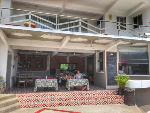 two people sitting at a table in a restaurant at Villa Aikia (Adults Suites A/C) in Zipolite