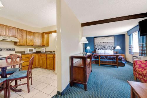 a kitchen and living room with a table and a dining room at Super 8 by Wyndham Hutchinson in Hutchinson