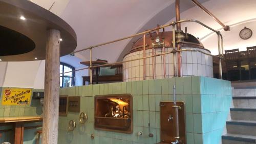 a kitchen with a pizza oven in a room at Hotel Gasthof Traubenbräu in Krumbach