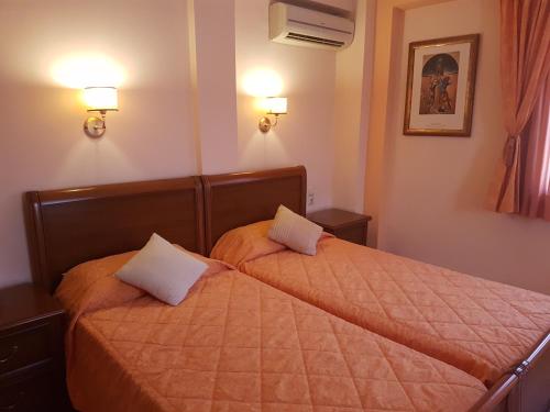 two beds in a hotel room with two pillows at Yiannis Apartments in Ioannina