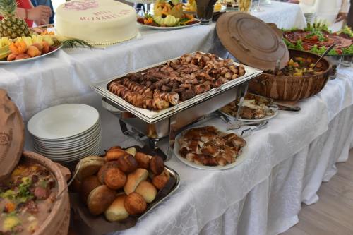 a buffet of food on a table with plates of food at Garni Hotel Mlinarev san in Arilje
