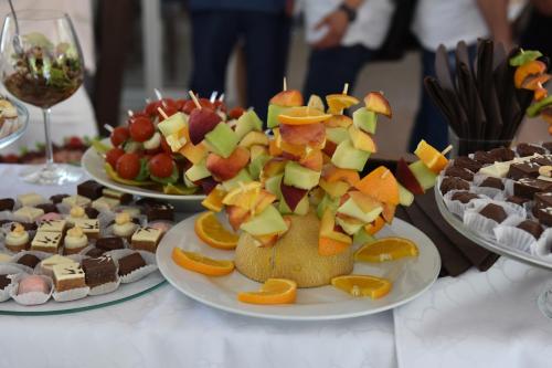 a table with several plates of food on it at Garni Hotel Mlinarev san in Arilje