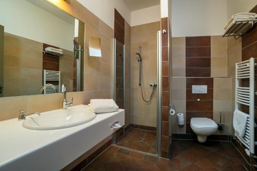 a bathroom with a sink and a toilet at Waldhotel in Graal-Müritz