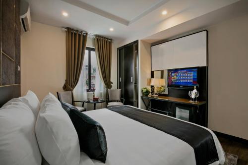 a hotel room with a bed and a television at La Santé Hotel & Spa in Hanoi