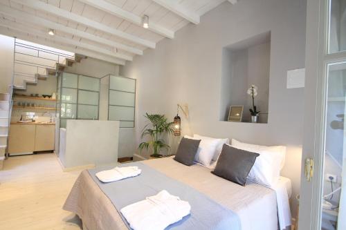 a bedroom with a bed with two towels on it at Fagotto Art Residences in Chania Town