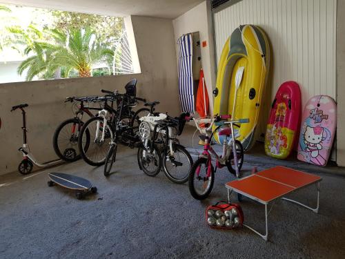 a group of bikes parked in a room with surfboards at Apartments at Commodoro in Villeneuve-Loubet