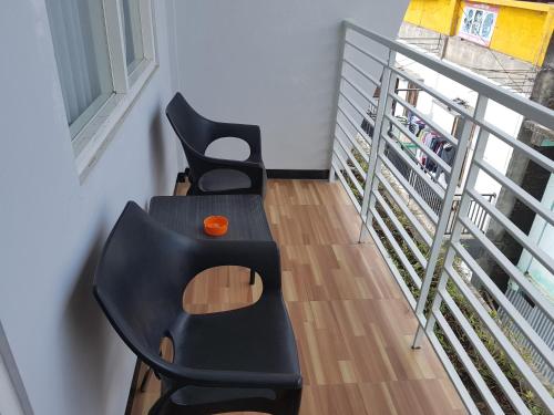 two black chairs sitting next to a staircase at Matahari Hotel Labuan Bajo in Labuan Bajo