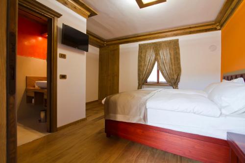 Postel nebo postele na pokoji v ubytování B&B alla Piazzetta