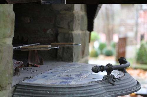 a close up of a brick oven with a wheel at Trumpet House in Leuven
