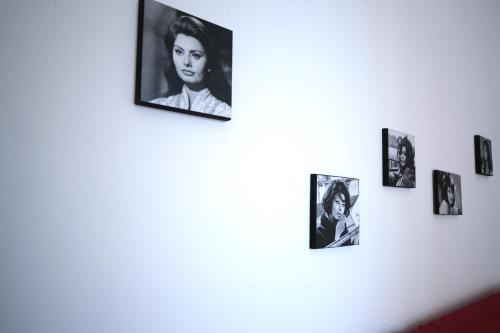 a group of pictures hanging on a wall at Napoliamo Guest House in Naples
