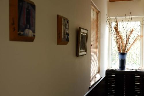 a room with a window and a vase on a table at Bridge12th B&B in Yanliau
