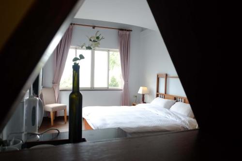 a bedroom with a large bed and a window at Bridge12th B&B in Yanliau