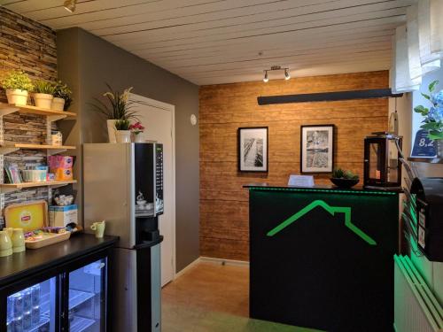 a kitchen with a green arrow on the wall at Virserum Hostel in Virserum