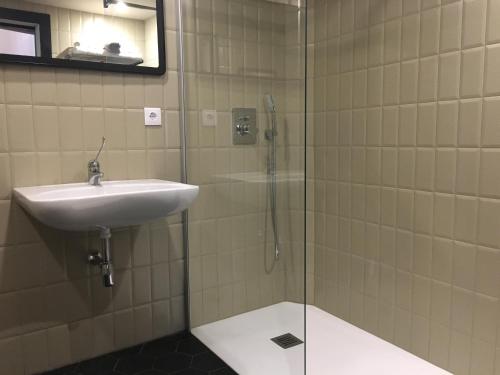 a bathroom with a sink and a glass shower at MD Design Hotel - Portal del Real in Valencia