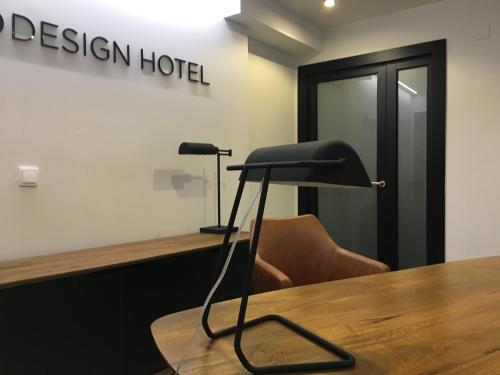 a black chair sitting at a table in a room at MD Design Hotel - Portal del Real in Valencia