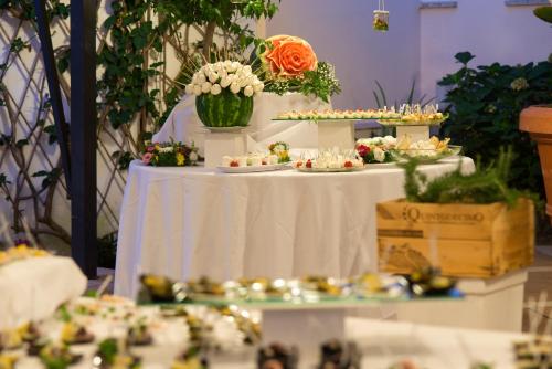 a table with a white table with desserts on it at Hotel Villa Durrueli Resort & Spa in Ischia