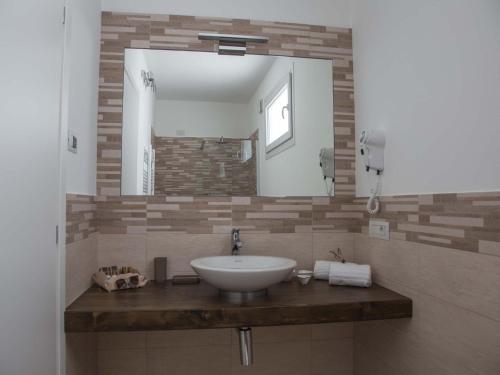 a bathroom with a sink and a mirror at Villa La Rosa B&B in Bellagio