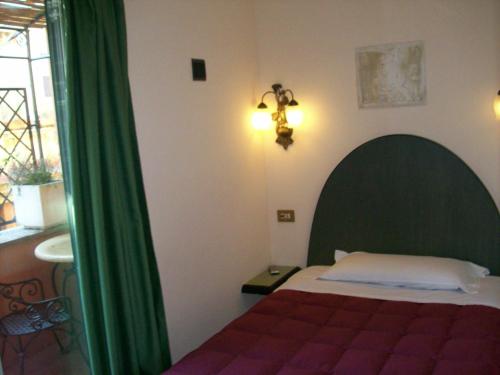 Postel nebo postele na pokoji v ubytování Hotel Prati