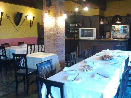 a dining room with white tables and black chairs at Albergo Bar Brenve in Issogne