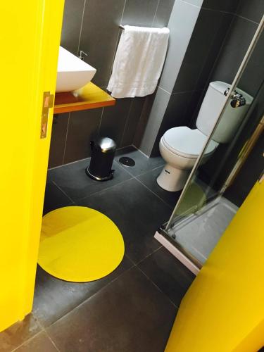 a bathroom with a toilet and a sink at Globo Happy Hostel in Angra do Heroísmo