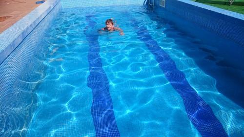 a person swimming in a swimming pool at Nawiady 18A in Piecki