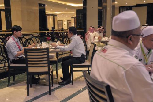 a group of people sitting at a table in a restaurant at Saja Al Madinah in Al Madinah