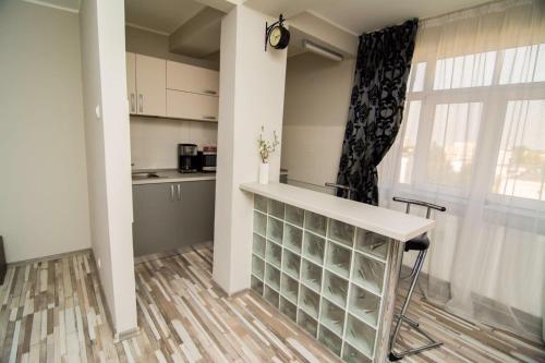 a kitchen with a white counter and a window at Studio Casa in Galaţi