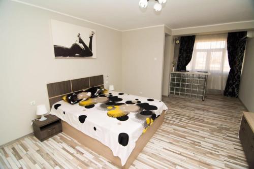 a bedroom with a black and white cow bed at Studio Casa in Galaţi