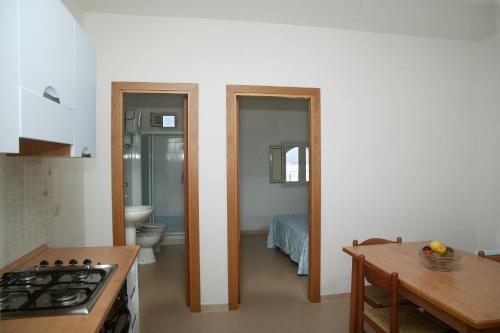 a kitchen with a sink and a toilet in a room at Villaggio Bellariva in Peschici
