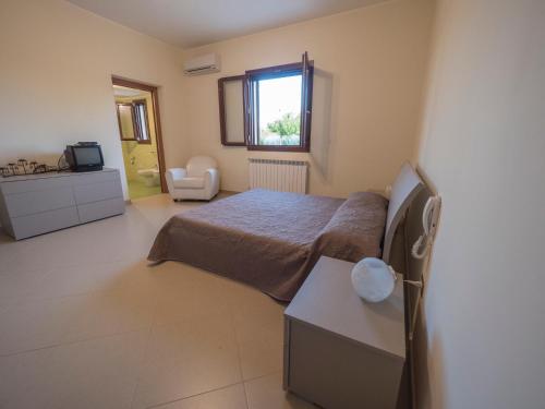 a bedroom with a bed and a sink and a window at Nel Cuore Del Salento in San Donato di Lecce