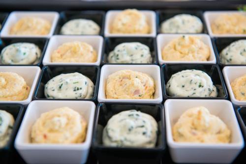 a bunch of cupcakes in white dishes with cream at Grid Hotel in Brno