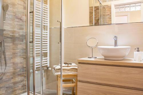 a bathroom with a sink and a shower at Taormina Family Apartment in Taormina