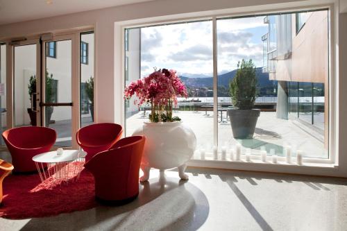 a room with a large window with a vase with flowers in it at Quality Hotel Waterfront in Ålesund