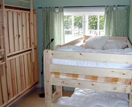 a bedroom with two bunk beds and a window at Vimmerby Vandrarhem in Vimmerby