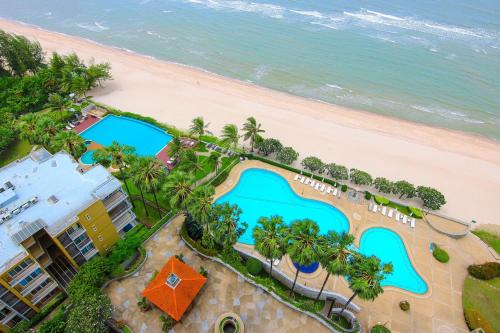 an overhead view of the pool and beach at Cha am Beach Club in Phetchaburi