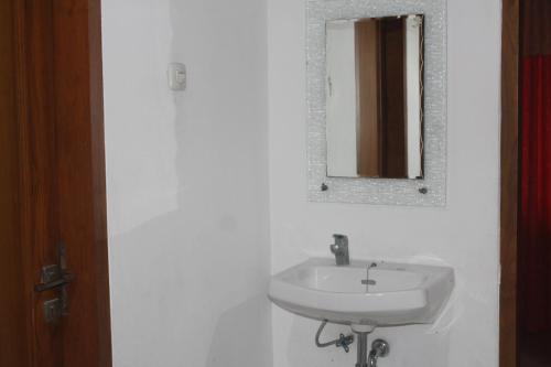 a bathroom with a sink and a mirror on the wall at Rabbani Family Homestay in Yogyakarta