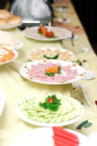 a long table with plates of food on it at Hoang Yen Hotel in Thuan An