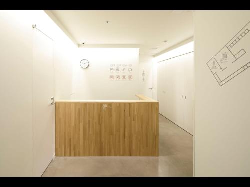 a hallway with a wooden counter in a room at 9h nine hours woman Kanda in Tokyo