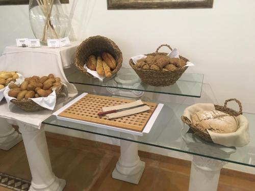 a glass table with some baskets of food on it at Mon Port Hotel & Spa in Port d’Andratx