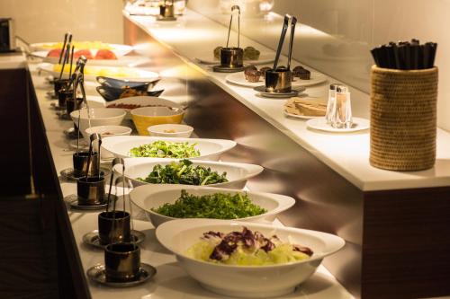 a buffet line with plates of food on it at Summit Hotel Seoul Dongdaemun in Seoul