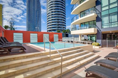 a swimming pool in a city with tall buildings at Mantra Broadbeach on the Park in Gold Coast
