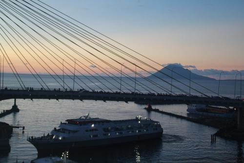 a large boat in the water under a bridge at Hotel Celebes in Manado