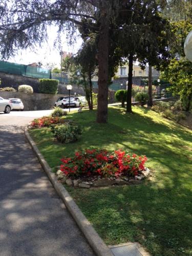 a park with red flowers in the grass at Appartamento del Golf - Secured Parking - in Rapallo