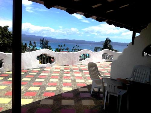 a view of a patio with chairs and a checkered floor at Aquarius Terraces Boutique Resort in Boracay