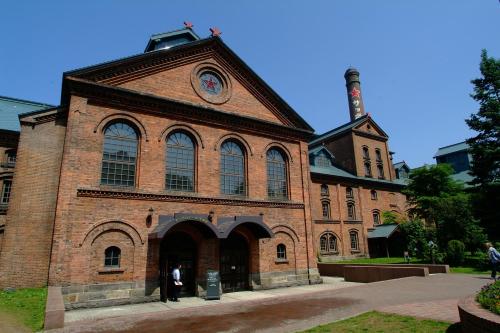 a large brick building with a clock on it at La'gent Stay Sapporo Odori Hokkaido in Sapporo
