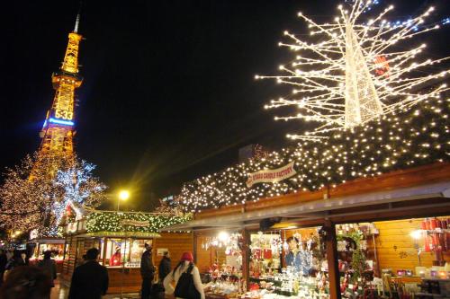 a christmas market with the eiffel tower in the background at La'gent Stay Sapporo Odori Hokkaido in Sapporo