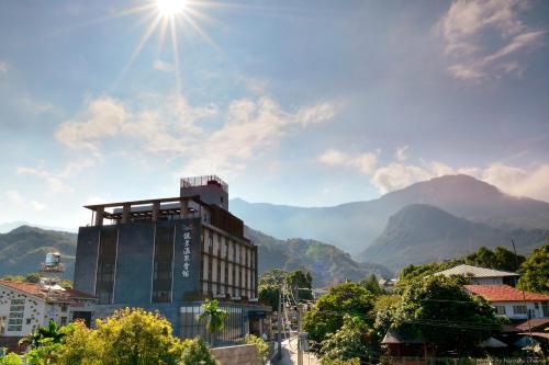 a building in a city with mountains in the background at Reikei Hot Spring Resort in Baihe