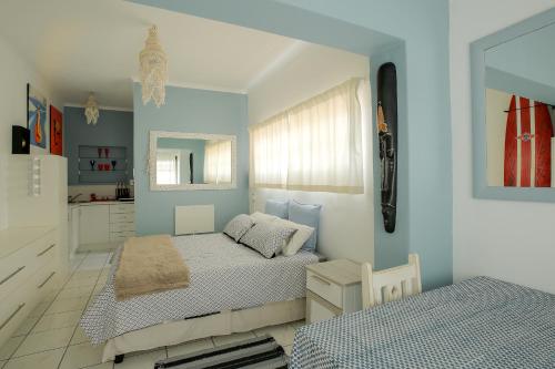 a bedroom with two beds and a mirror at J Bay Dreaming in Jeffreys Bay