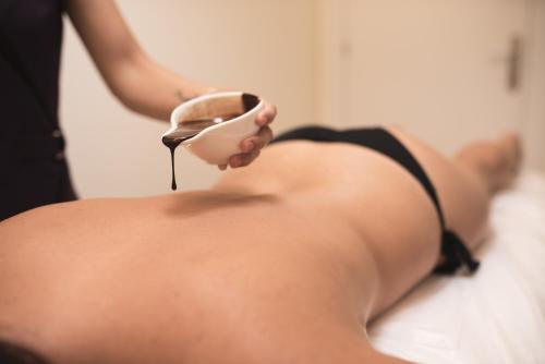 a woman in a bikini holding a hair brush at Hotel Pompaelo Plaza del Ayuntamiento & Spa in Pamplona